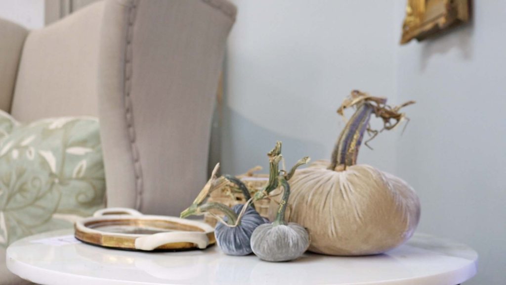 Amitha Verma decorates small side tables using velvet pumpkins from her Houston shop, Village Antiques, in medium and small sizes.