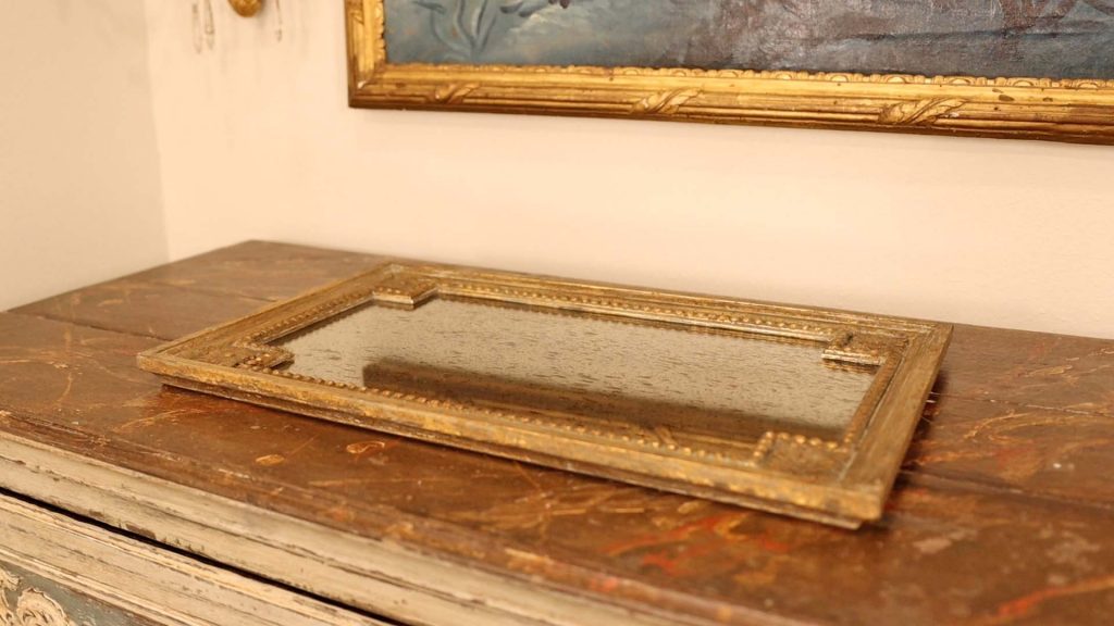 To top her farmhouse furniture, Amitha Verma adds a gold antique style tray on top to add a touch of character.