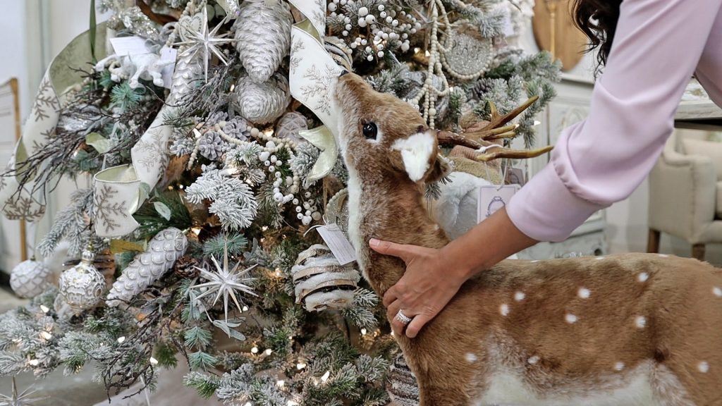 At the base of the French country Christmas tree, Amitha VermaI placed a standing stuffed deer. It's intentionally placed as if it is looking up at it with wonderment, just like a child might.