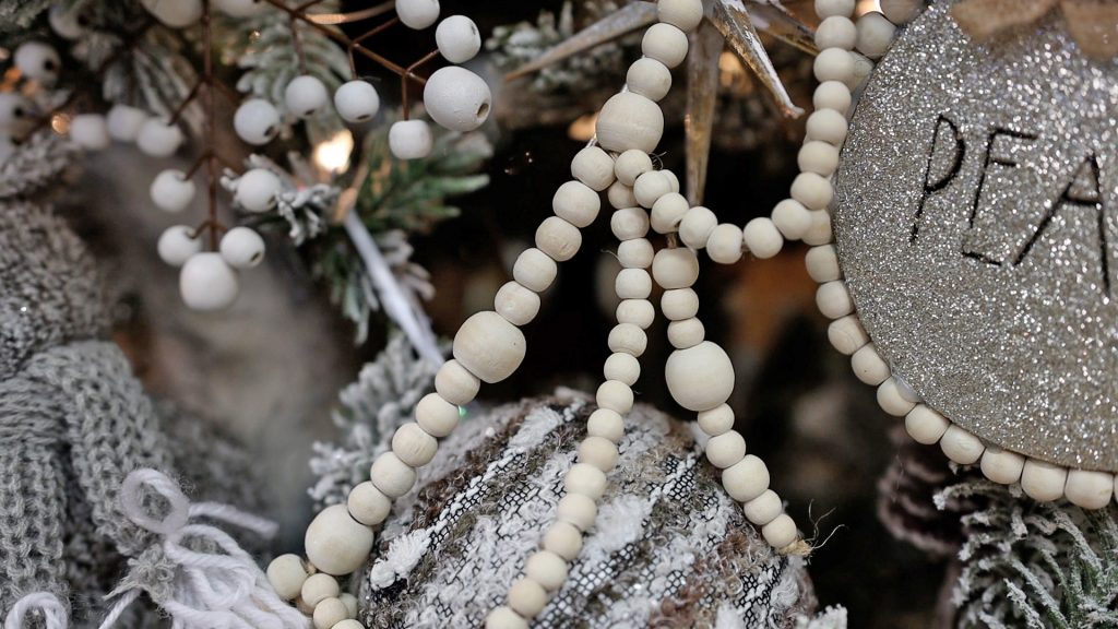 To complete her French country Christmas tree, Amitha Verma used a wooden beaded garland to add to the natural color palette and whitewash elements.