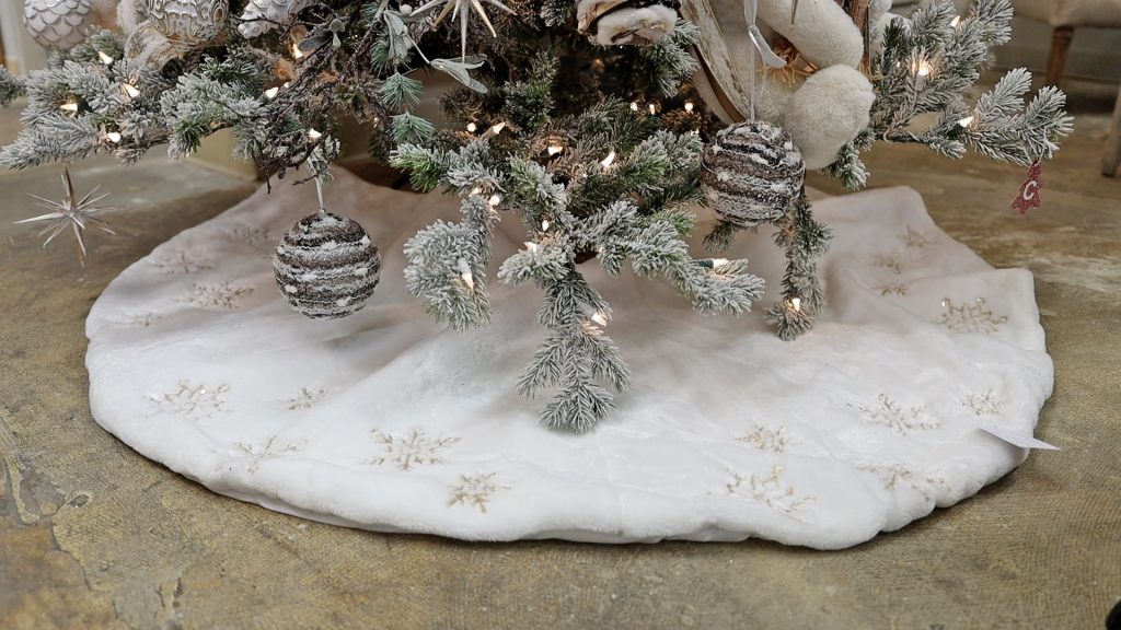 At the bottom of the French country Christmas tree, Amitha Verma used a snowy white, textural tree skirt. 