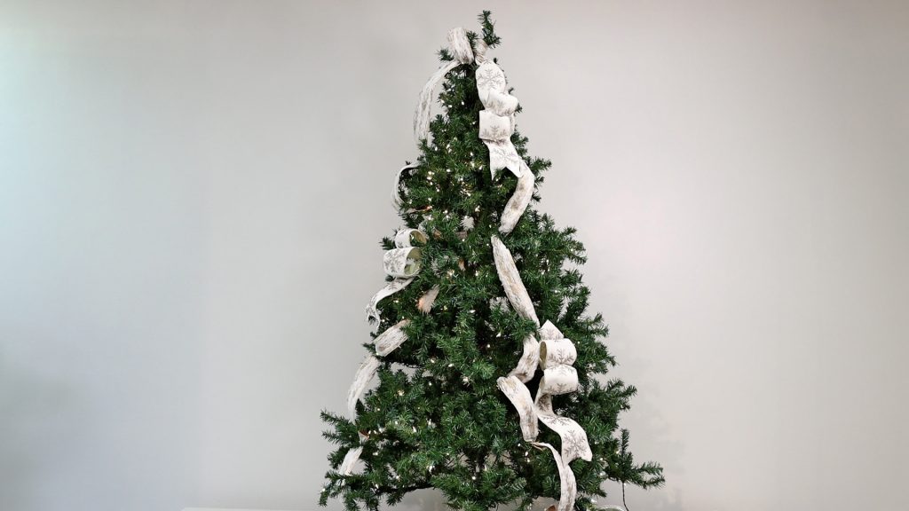 Amitha Verma places her looped ribbon technique to her farmhouse Christmas tree in a zigzag pattern, starting from the top and then going diagonally. 