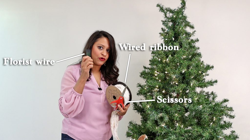 To attach wired ribbons to a farmhouse Christmas tree, Amitha Verma uses her ribbon, florist wire, and a pair of scissors.