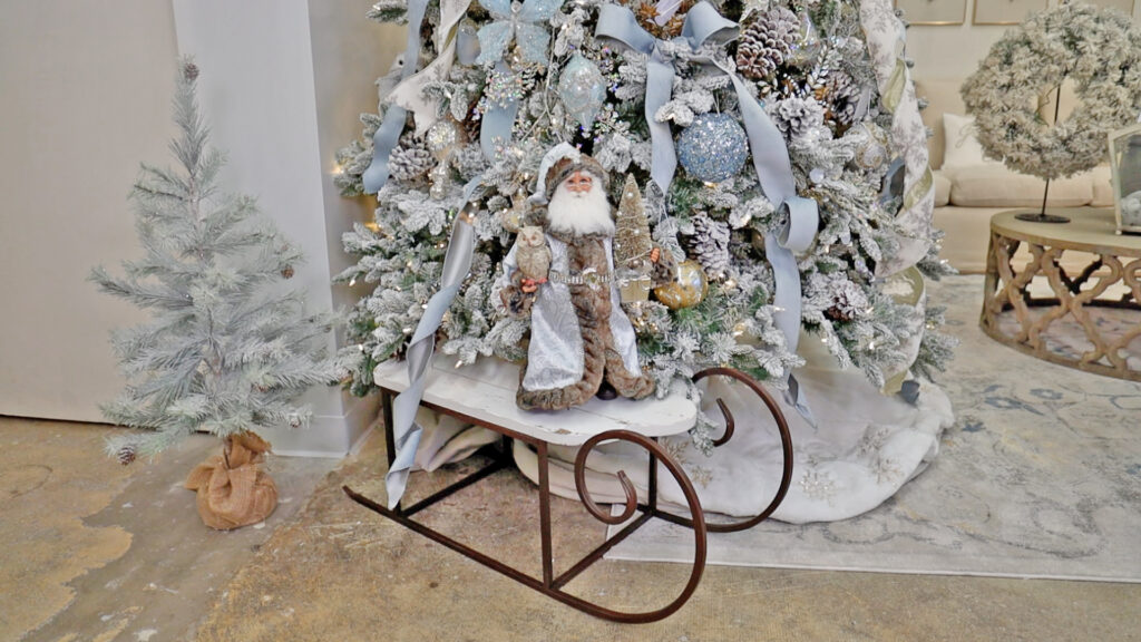 At the bottom of Amitha Verma’s French blue tree, she placed a whitewashed, chalky painted sled and used it as an opportunity to plop on a Santa to blend in seamlessly with this tree.