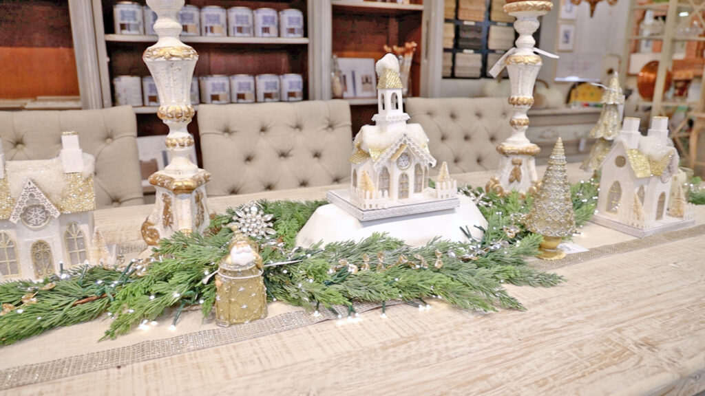 To replicate a dining room setting, Amitha Vemra added a thin garland and gold Christmas decor to a tablescape design at Village Antiques.