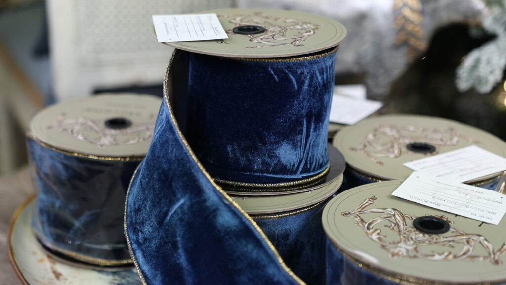 Velvet ribbons such as the ones sold at Village Antiques in Houston, TX, are a major  Christmas décor trend for 2022.